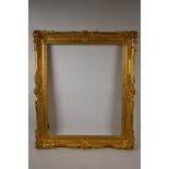 A C19th gilt composition picture frame with scroll and leaf decoration, rebate 17½" x 21½"