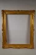 A C19th gilt composition picture frame with scroll and leaf decoration, rebate 17½" x 21½"