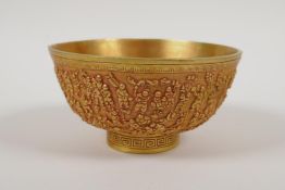 A Chinese gilt metal bowl with raised decoration of the '100 boys', 4 character mark to base, 5"