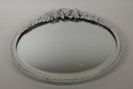 A metal framed barbola style oval wall mirror, 17" x 14"