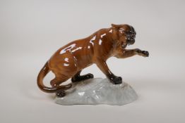 A Beswick figure of a puma on a rock, with a gloss finish, model 1702, 12" long