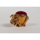 A miniature brass pinchushion in the form of a pig, 1" long