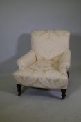 A Victorian armchair raised on turned supports, 30" high, 27" wide