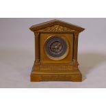 A C19th ormolu brass cased mantel clock with silvered chapter ring and Arabic numeral, the case with