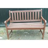 A stained and varnished teak garden bench, 47" long