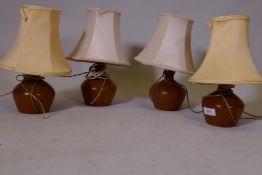 A set of four mid century teak table lamps, 8" high