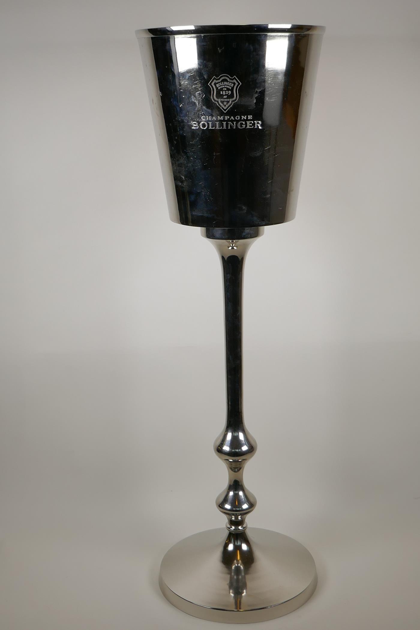 A electro plated pedestal champagne bucket, 32" high