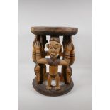 An African carved and stained wood figural stool, 16½" high x 12" diameter