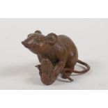 A Japanese bronze okimono in the form of a rat, 1½" high, 2½" long