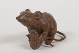 A Japanese bronze okimono in the form of a rat, 1½" high, 2½" long