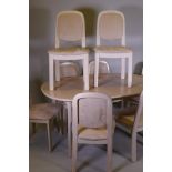 A G-Plan white ash dining table with fold out leaf and eight matching chairs, with faux suede