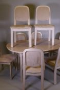 A G-Plan white ash dining table with fold out leaf and eight matching chairs, with faux suede