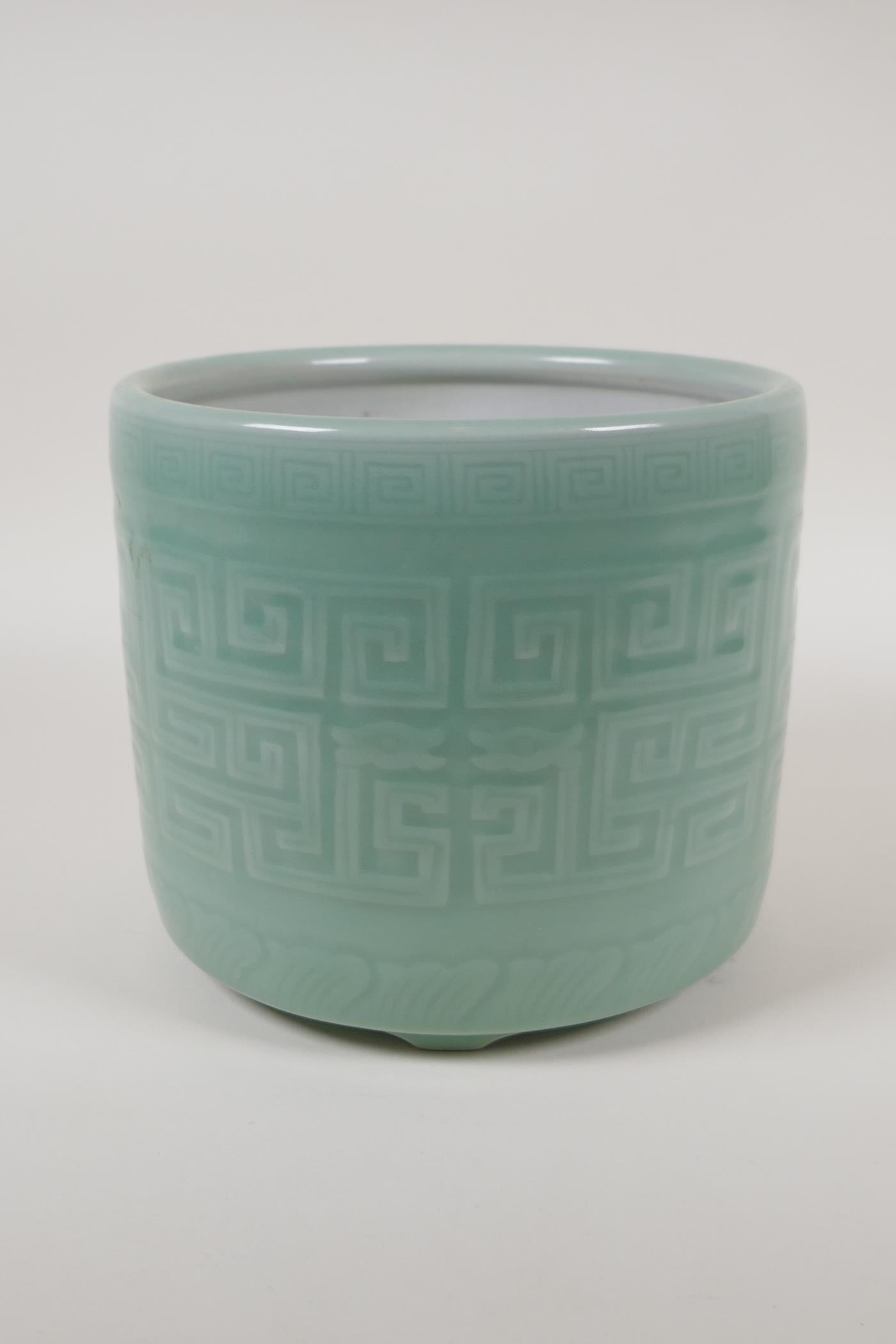 A Chinese  celadon glazed porcelain planter raised on tripod supports, with underglaze archaic style - Image 2 of 4