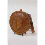 An Eastern European carved wood and brass mounted flask, with carved fruiting vine decoration and