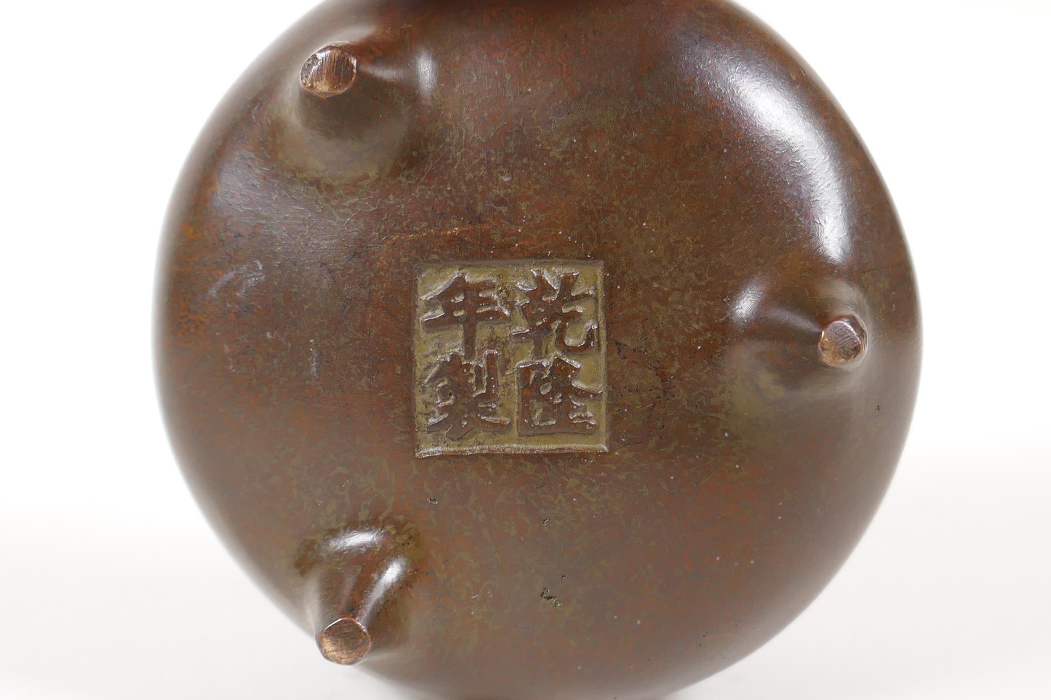 A Chinese bronze censer with two phoenix eye handles and tripod supports, impressed 4 character mark - Image 3 of 4