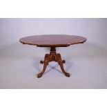 An oval top fruit wood coffee table on turned column and quadruple supports, 36" x 24", 19" high