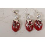 A suite of silver and coral stone set earrings and pendant