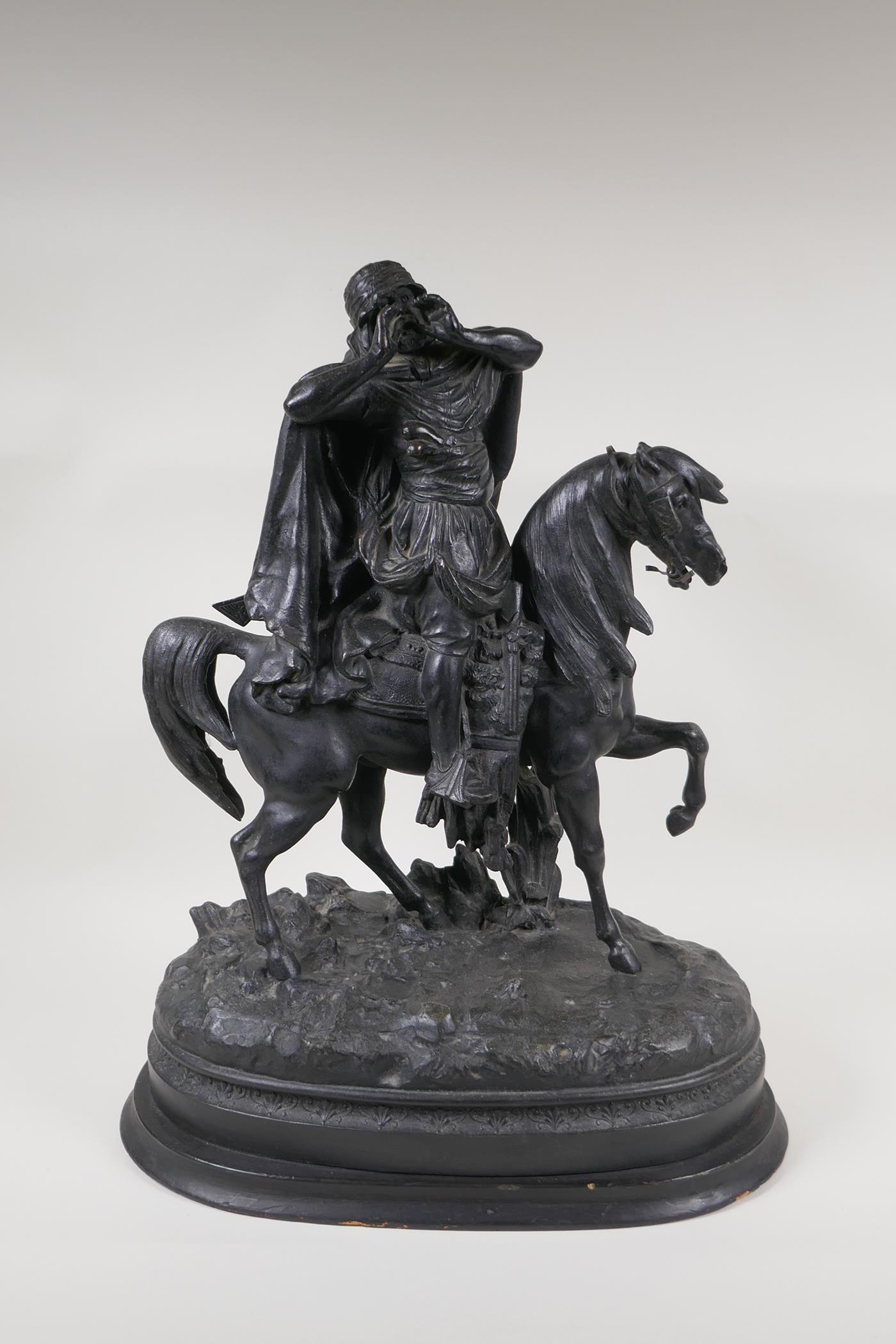 A bronzed spelter figure of an Arab on horseback, 19" high