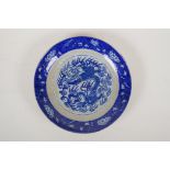 A Chinese crackleware dish with blue and white dragon decoration to the centre and prunus blossom to