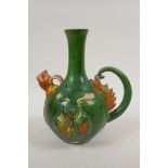 A Chinese tang style sancai glazed ewer with dragon decoration, 9½" high