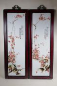 A pair of Chinese Republic period porcelain panels depicting branches in blossom, in hardwood