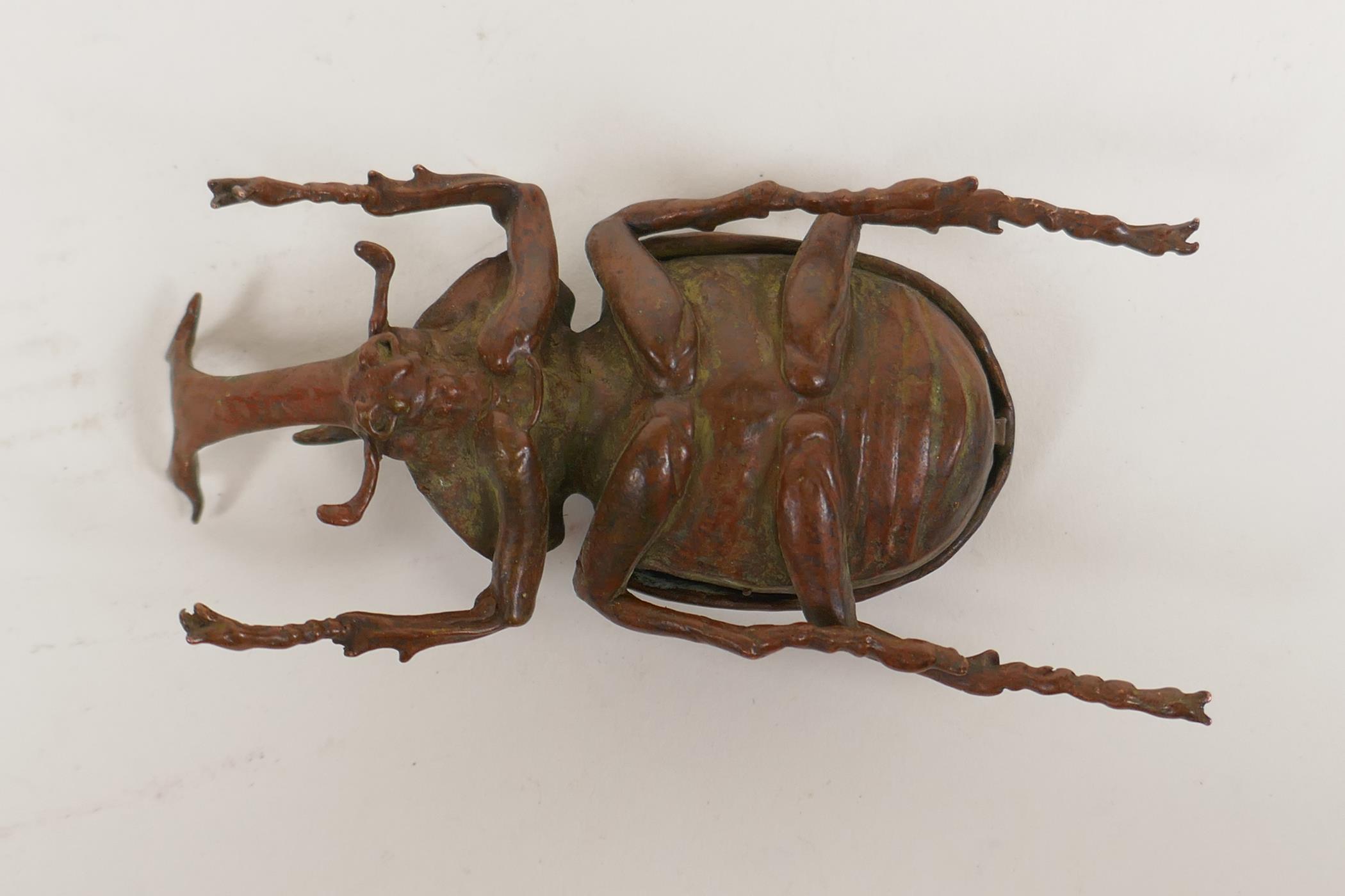 A Japanese Jizai style okimono in the form of a rhinoceros beetle, the carapace opening to reveal an - Image 5 of 5