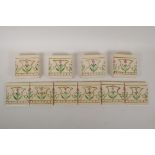 Eighteen cream ground hand painted tiles with floral pattern decoration, each tile 4¼" x 4¼"