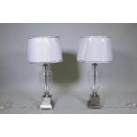 A pair of contemporary brushed steel and glass table lamps with shades, unused, 33" high to top of