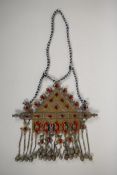 A Turkman metal ceremonial necklace with gilt and silvered details, ruby coloured stone settings and