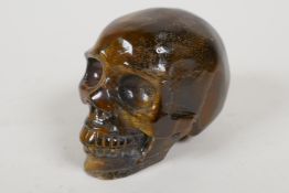 A carved tiger's eye skull, 2½" high