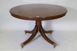 A Regency style mahogany centre/breakfast table with solid top, raised on a turned column with splay