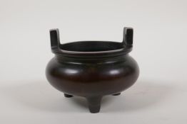 A Chinese two handled censer on tripod supports, impressed character mark to base, 4" diameter