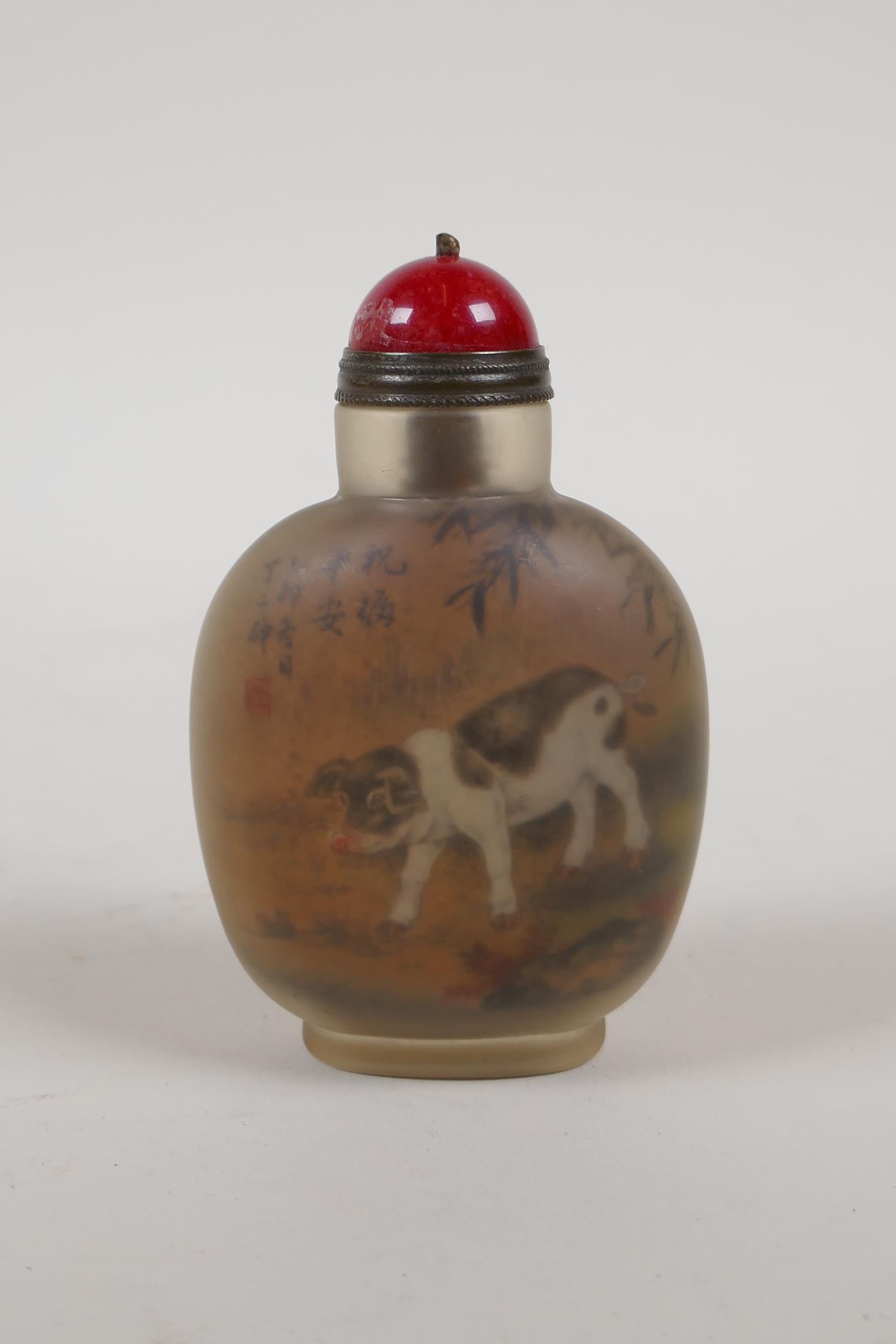 A Chinese reverse decorated glass snuff bottle depicting saddleback pigs, 3" high