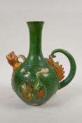 A Chinese tang style sancai glazed ewer with dragon decoration, 9½" high