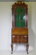 A Georgian style walnut fall front bureau bookcase, the upper section with dome top and fret