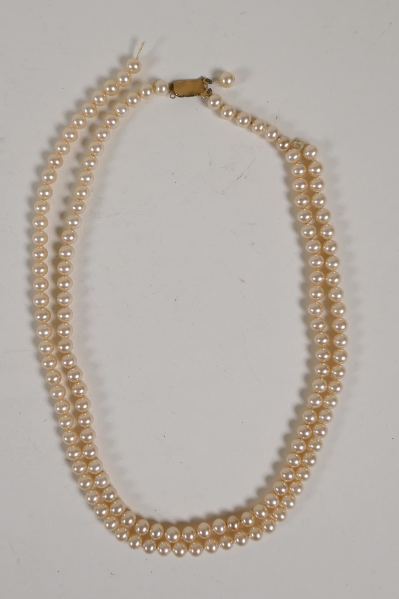 A Ciro pearl necklace with 9ct gold clasp, 18" long, and a string