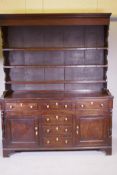 A Georgian oak North Country dresser, probably Lancashire, the delft rack with planked back, the