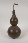 A Chinese bronze double gourd shaped flask, sealed, impressed Yin Yang mark to base, 12½" high