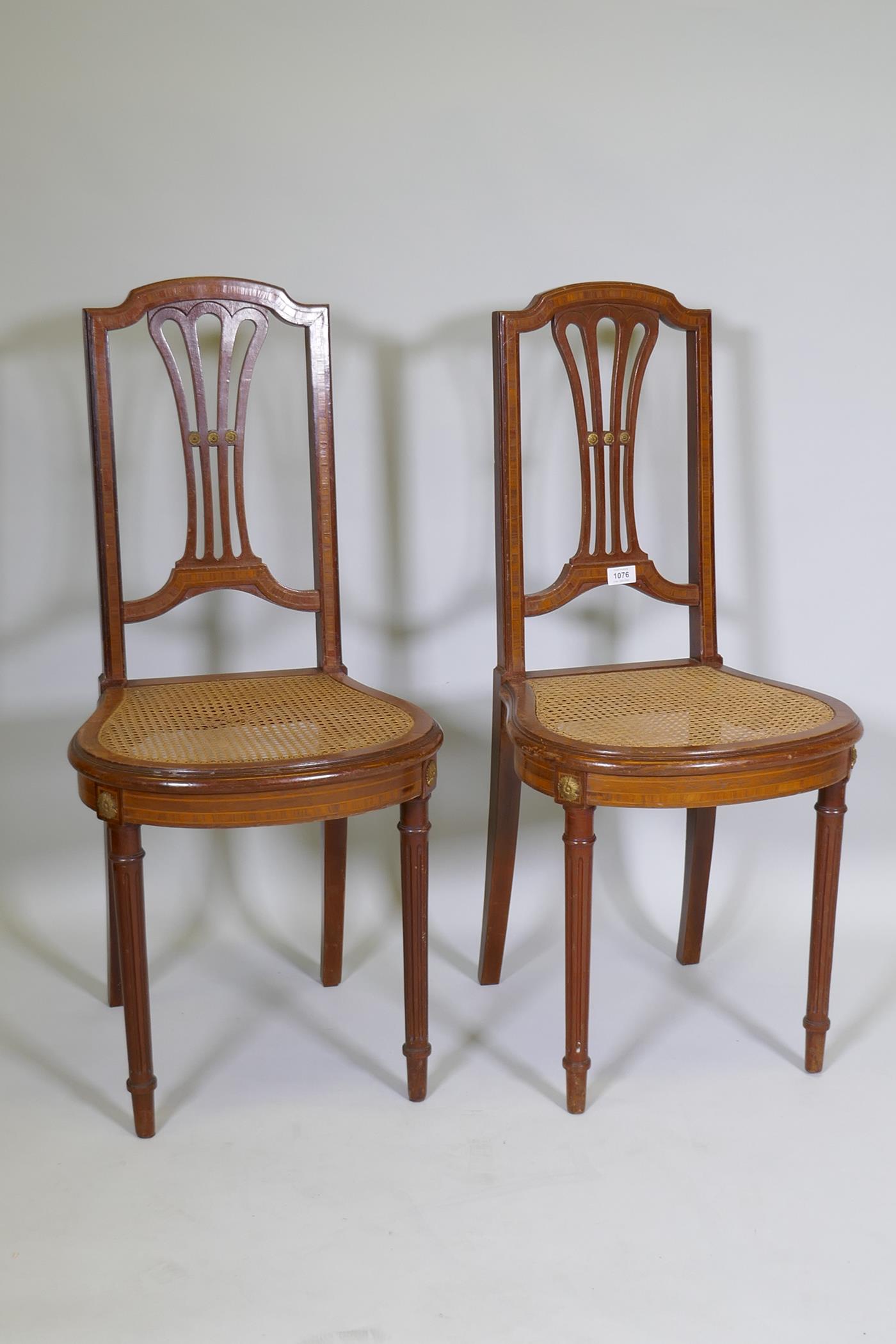 A pair of C19th continental neo-classical style mahogany and satinwood banded side chairs, with