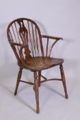A C18/19th Windsor hoop back yew wood elbow chair, with pierced splat back, shaped and scrolled arms