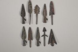 Ten archaic style bronze arrow heads, 3" long