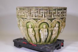 A large stone font, with carved decorationin the Romanesque style depicting the twelve apostles