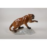 A Beswick figure of a puma on a rock, with a gloss finish, model 1702, 12" long