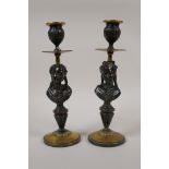 A pair of antique bronze and brass candlesticks with figural bust decoration of a lady, 9½" high