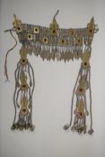 A Turkman metal headdress with gilt and silvered detail and ruby coloured stone settings, 18½" long,