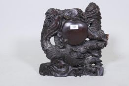 A Chinese hardwood panel, carved with a dragon and phoenix, 14" high