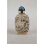 A Chinese reverse decorated glass snuff bottle depicting a musician and student, character