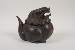 A Chinese bronze censer and cover in the form of a stylised temple lion with gilt and coppered