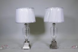 A pair of contemporary brushed steel and glass table lamps with shades, unused, 33" high to top of