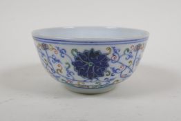A Chinese polychrome porcelain rice bowl with scrolling lotus flower decoration, early C20th,
